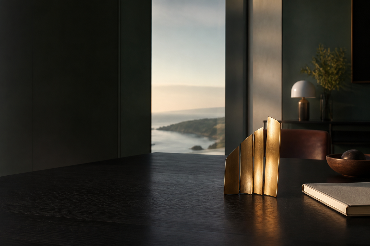 Warm light on a quiet strategic workspace with an abstract three-part brass sculpture.